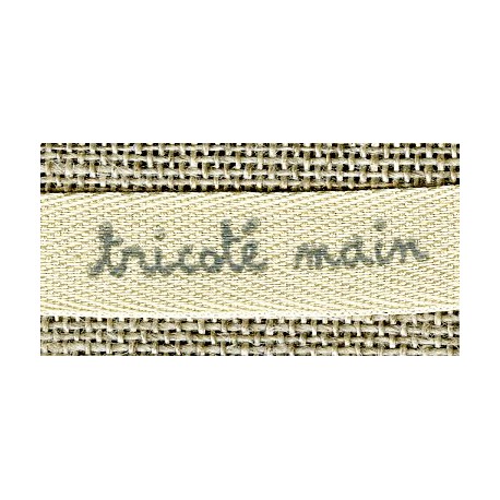 Beige ribbon printed grey lettering: Woven Hand