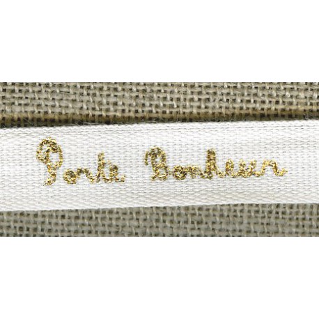 White ribbon printed gold lettering: Lucky charm